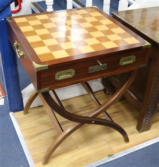 A Waterloo chess set by Charles Stadden, No. 27/250, in military style brass-bound mahogany games table on folding stand